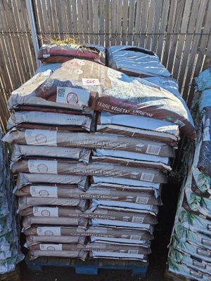many bags of food sitting on top of a pallet
