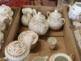 a box full of teapots and cups on a table