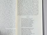 someone is reading a book on a table with an open page
