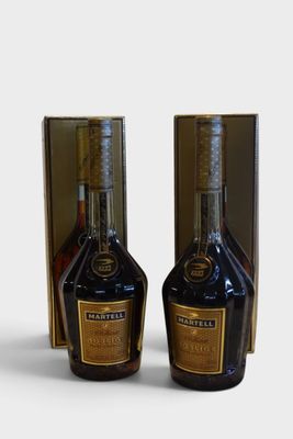 two bottles of liquor sitting next to each other on top of a table