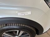 a close up of a white car with a sticker on it
