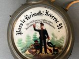 a silver pocket watch with a picture of a man on a boat