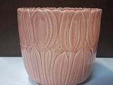 a pink bowl that is sitting on a table