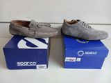 two pairs of men ' s shoes sitting on top of a blue box