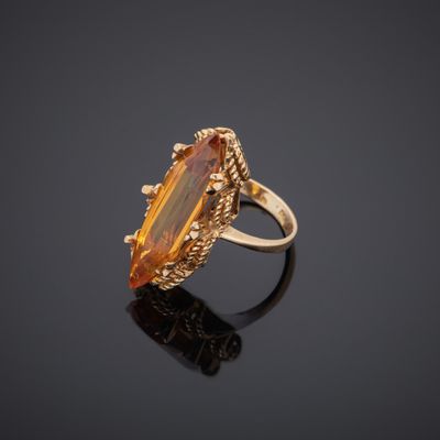 a gold ring with a large citrine stone in the center