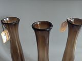 three brown vases sitting on a table with tags on them