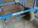 a blue cart that has a tire on it