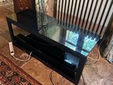 a television that is sitting on top of a glass table