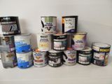 many cans of paint sitting on a shelf next to each other
