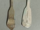 two spoons sitting next to each other on a table