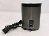 a close up of a speaker with a power cord attached to it