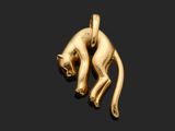 a close up of a gold cat pendant on a black background