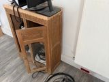 a television sitting on top of a wooden stand next to a radiator