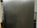 a stainless steel refrigerator in a small kitchen