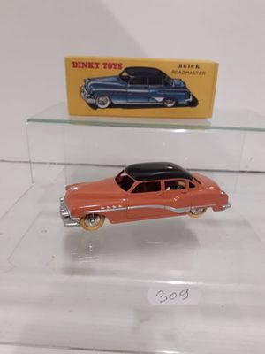 two toy cars on display in a glass case