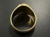 a close up of a gold ring on a black surface