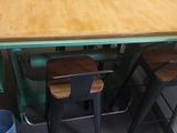 a kitchen table with four stools and a table top