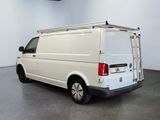 the white van is parked in a large room with a ladder on the roof
