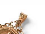 a gold pendant with a picture of a woman on it