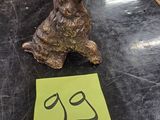 a small dog figurine sitting on a table next to a piece of paper