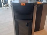 a black stove sitting in the middle of a room