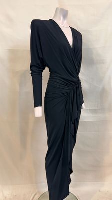 the dress is black and has long sleeves and a tie around the waist