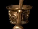brass mortar and pestula on a black background with a black background