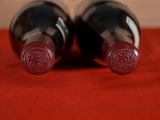 two bottles of wine sitting next to each other on a table