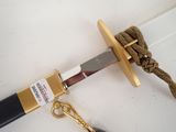 a knife with a gold handle and a black handle