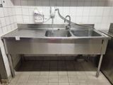 a stainless steel sink in a commercial kitchen