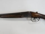 a rifle with a wooden barrel and a wooden handle
