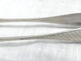 two spoons that are sitting on a table