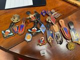 a lot of badges on a table next to a laptop