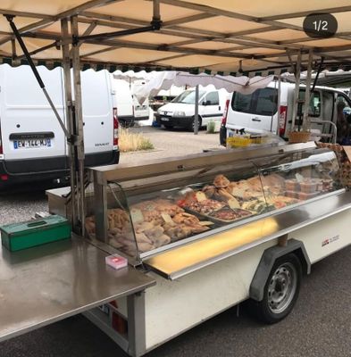 a food cart that has a lot of food inside of it