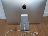 a white apple computer sitting on a wooden floor