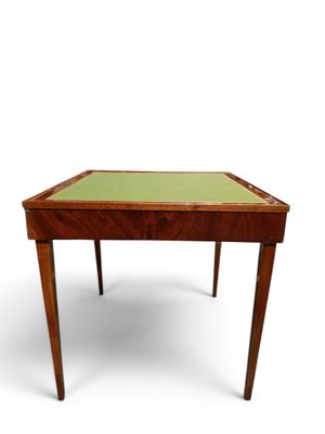 an image of a small wooden table with a green top