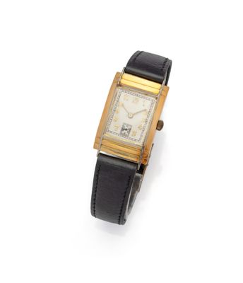a gold plated wrist watch with a black leather band