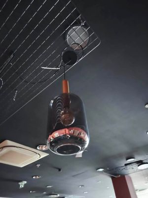 une bouteille en verre suspendue au plafond d'un restaurant