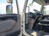 a white truck with the door open and the driver ' s seat down