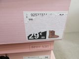 a pink box that has a pair of shoes on top of it