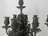 a large metal candelier with five candles on it