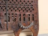 a wooden bench with carvings on it in a room