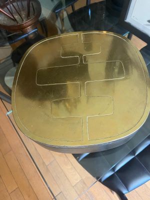a glass table with a gold plate on top of it