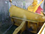 a yellow machine that is sitting in the grass