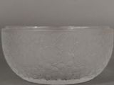 a glass bowl with a pattern on it on a table