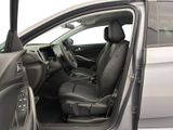 the interior of a car with the door open and the driver ' s seat down