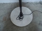 a white umbrella with a black handle on a cement floor