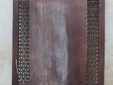 an old wooden door with a decorative design on it