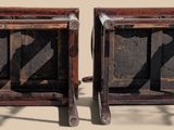 two wooden chairs that are sitting next to each other