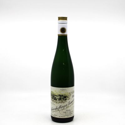 a bottle of wine sitting on top of a white table
